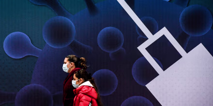 A child and parent arrive to receive a dose of the Covid-19 vaccine in Lisbon, Portugal on Dec. 18, 2021.