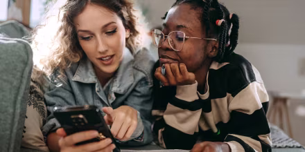 Friends looking at cell phone