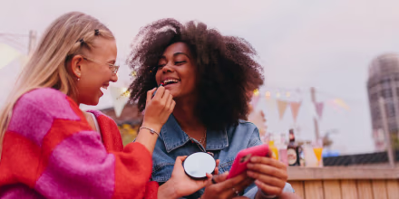 Generation z girl friends hanging out together outdoors in the city. 