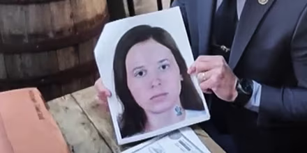 NYPD Detective Ryan Glas holds a digital composite photo of Patricia Kathleen McGlone.