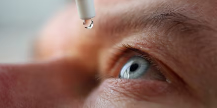 Man drops eye drops install lenses, moisturizing