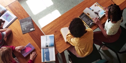 High angle view of students reading books