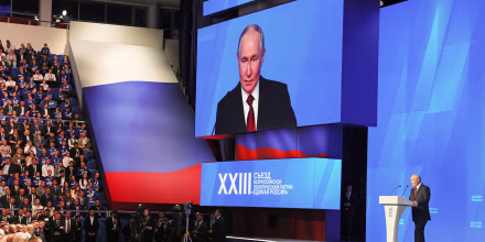 Image: Vladimir Putin on stage addressing an audience