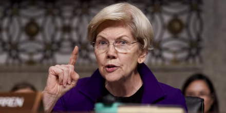 Elizabeth Warren holds one finger up while speaking during a Senate hearing.