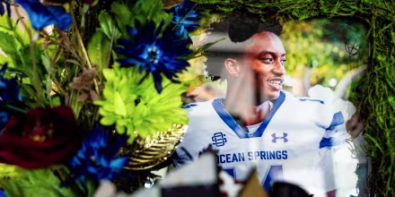 A photo of Nolan Wells surrounded by flowers