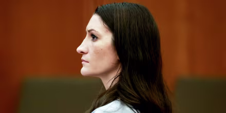 Side profile of Lindsay Clancy sitting inside of a court room