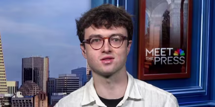 Jacob Coxon speaks while seated on the set of Meet the Press
