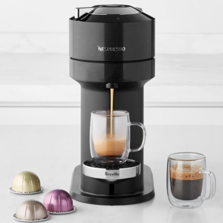 espresso machine brewing coffee on white counter