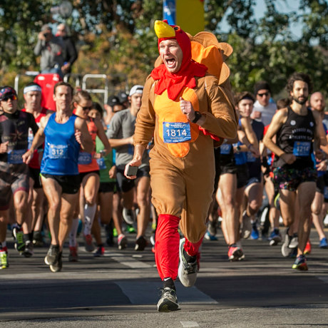 Chris Conlan leads the runners at the start of the 27th annual ThunderCloud Subs Turkey Trot in downtown Austin, Texas, on Nov. 23, 2017.