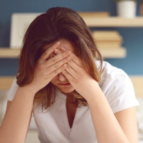 Unhappy woman in a bedroom