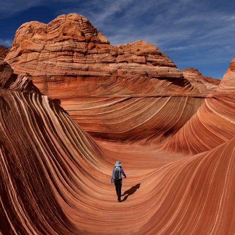 Image: Hikers walk through \"The Wave\" rock formation in the Coyotes Buttes North wilderness area in Arizona in 2017.