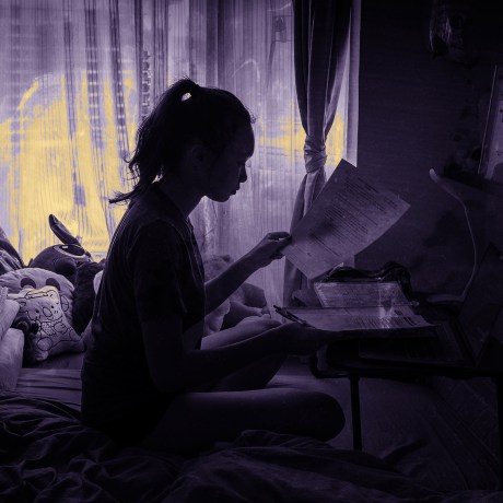 Image: Chloe Lau, a high school student in Hong Kong, does her schoolwork at home on March 4, 2020.