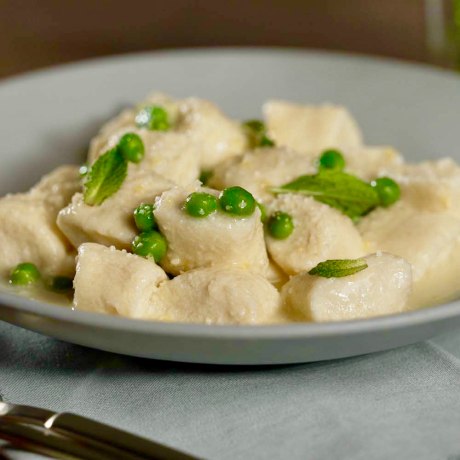 Homemade ricotta gnocchi gets smothered in a lemony butter sauce with mint and spring peas.