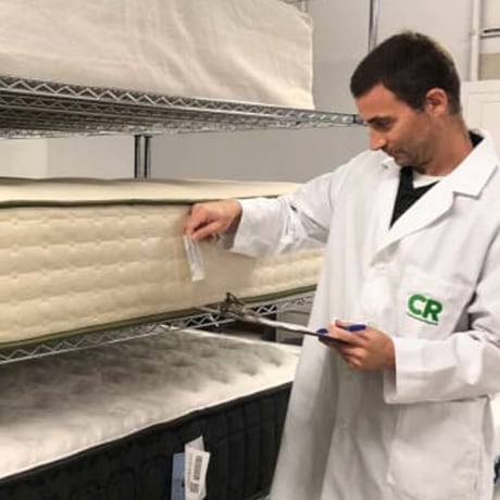 CR test engineer Chris Regan inspects new mattresses before testing begins.