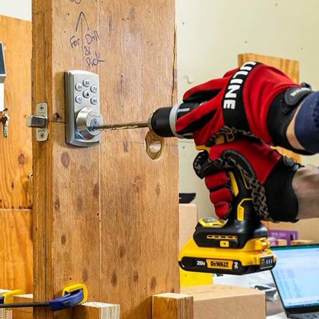 A Consumer Reports engineer uses a cordless drill to test door locks.