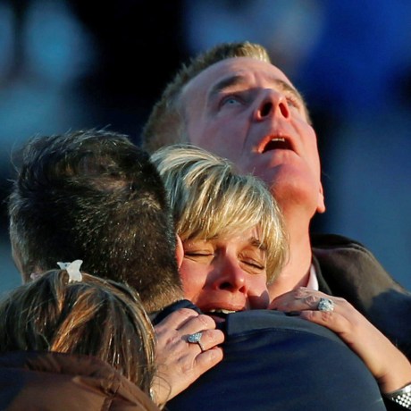 Lynn and Christopher McDonnell, the parents of seven-year-old Grace McDonnell, grieve near Sandy Hook Elementary after learning their daughter was one of 20 school children and six adults killed after a gunman opened fire inside the school in Newtown, Con