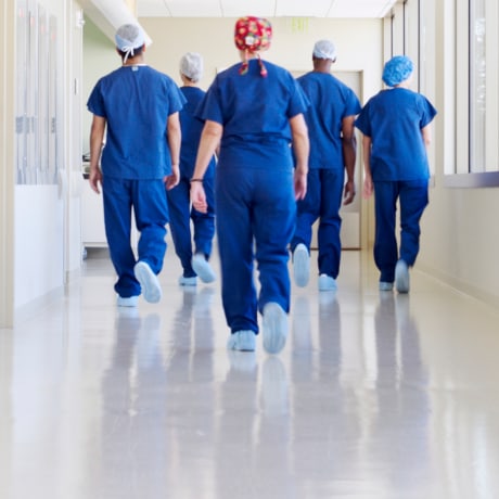 Surgical team walking down hospital corridor      