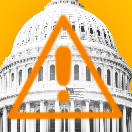 Photo Illustration: The Capitol building with an orange warning sign emblazoned on it