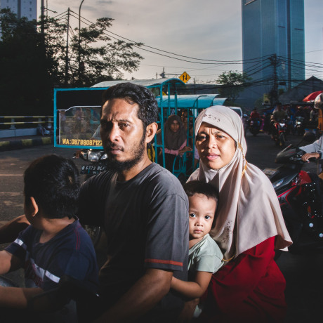 A family rides a scooter in the city center of Jakarta, Indonesia in 2022. 