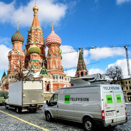 RT vans parked in front of St. Basil's Cathedral and the Kremlin next to Red Square