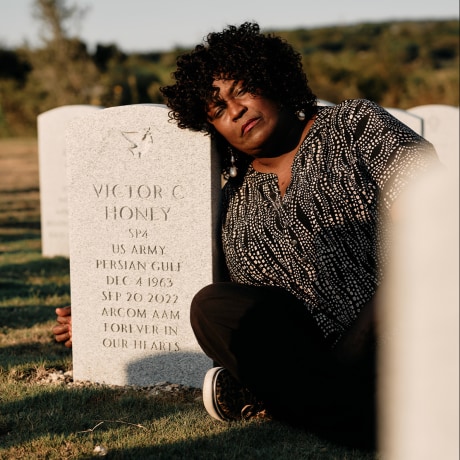 Kimberly Patman, the estranged ex-wife of Victor Honey, sits next to his grave at the Dallas-Fort Worth National Cemetery on Sept 15, 2024. 