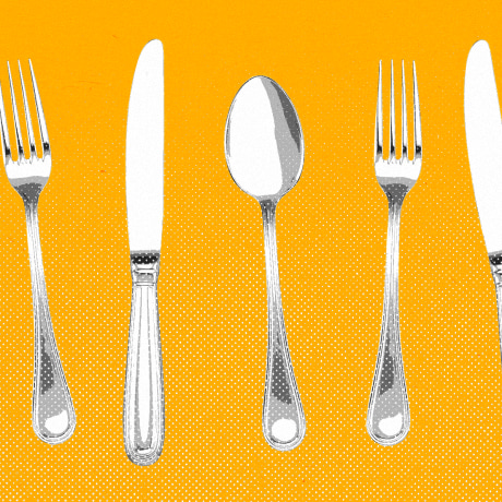Forks, knives, and spoons lined up against a yellow background.