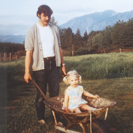 Father giving daughter wheelbarrow ride