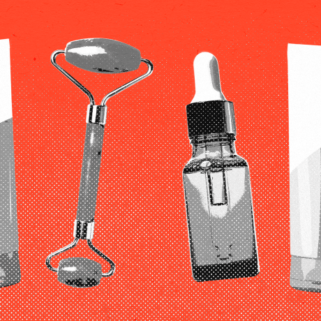 Repeating pattern of skincare cream tube, jade roller, and dropper bottle against a red background.