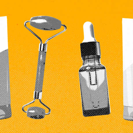 Repeating pattern of skincare cream tube, jade roller, and dropper bottle against a yellow background.