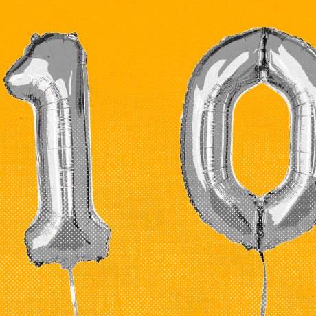 Balloons that spell the number 100, against a yellow background.