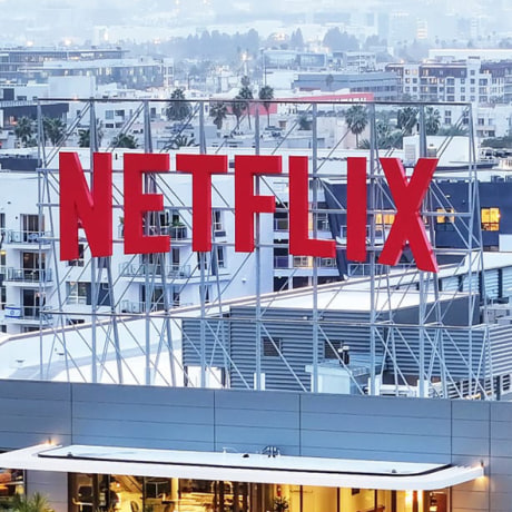 A split of the Warner Bros. and Netflix logo.