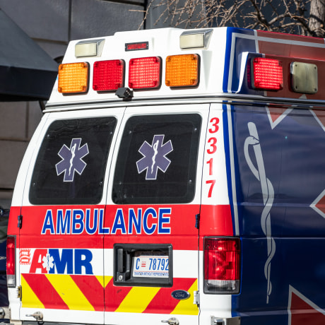 AMR (American Medical Response) logo on side of an ambulance on a scene in downtown Washington, D.C.