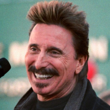 Chuck Negron sings into a microphone