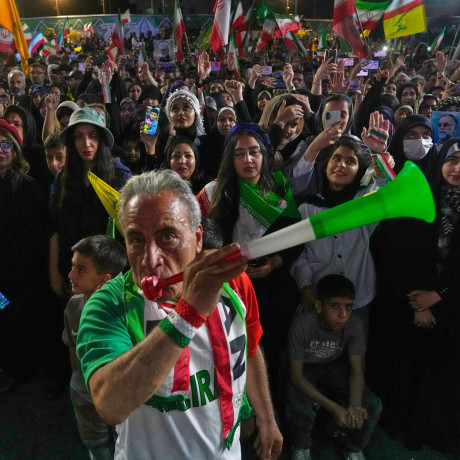 A man blows a plastic trumpet during a rally in support of Iran's World Cup team in Tehran on May 13, 2026.