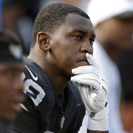 Aldon Smith, then playing for the Raiders, sits on the bench during the second half of the team's game on Sept. 13, 2015. Smith also played for the Seahawks and the 49ers, who announced his death on Saturday.