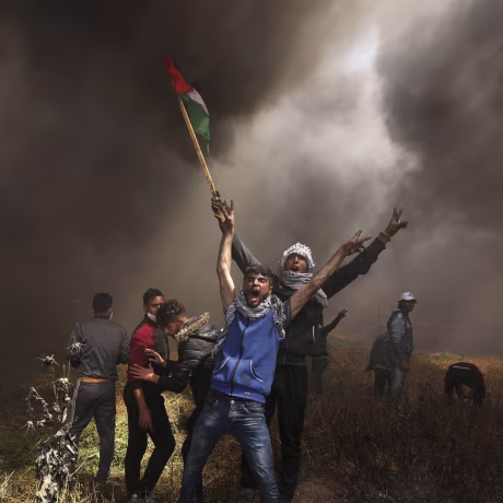 Image: Palestinian demonstrators shout during clashes with Israeli troops at a protest at the Israel-Gaza border east of Gaza City
