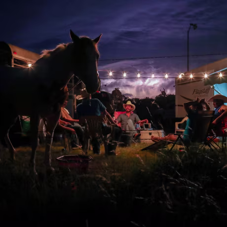 Image: Lightning fills the sky as cowboys from the Rio Grande Valley set up camp after arriving for Memorial Day weekend