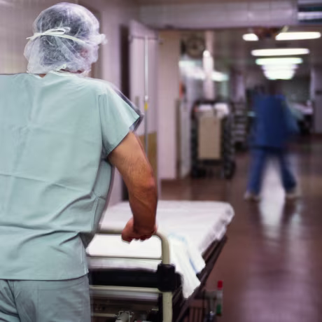 Image: A man pushes a stretcher in a hospital