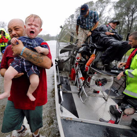 Image: Oliver Kelly, 1 year old, cries as he is carried off the sheriff's airboat during his rescue from rising flood waters in the aftermath of Hurricane Florence in Leland, North Carolina