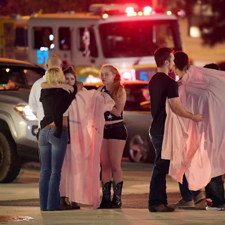 Image: People comfort each other as they stand near the scene Thursday, Nov. 8, 2018, in Thousand Oaks, Calif. where a gunman opened fire Wednesday inside a country dance bar crowded with hundreds of people on \"college night,\"