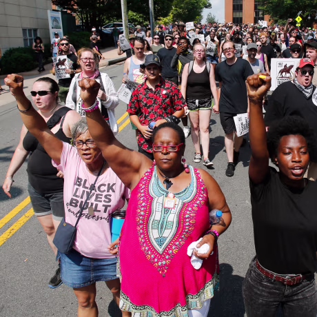 Image: Demonstrators against racism march along city streets as they mark the anniversary of last year's Unite the Right rally in Charlottesville