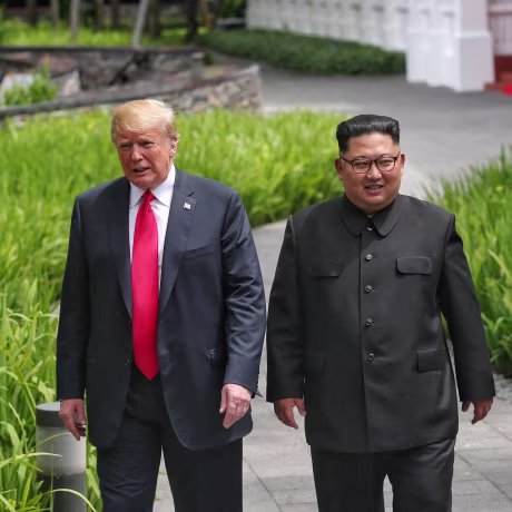Image: U.S. President Donald Trump walks with North Korean leader Kim Jong Un at the Capella Hotel on Sentosa island in Singapore