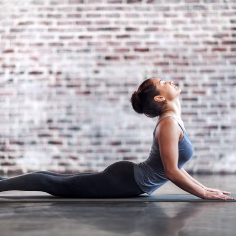 Young Woman Doing Yoga Meditation and Stretching Exercises