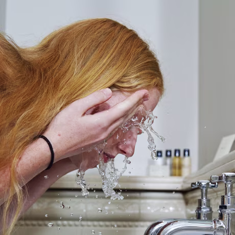 Woman washing her face