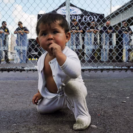 Image: A Mexican baby is seen in front of the gates to the Gateway International Bridge in Matamoros