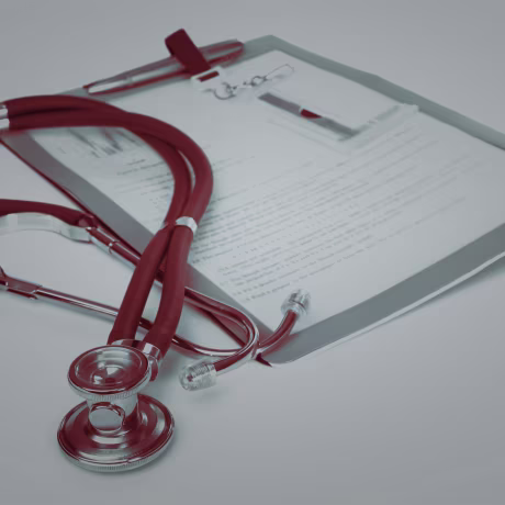 Stethoscope and a report isolated over white