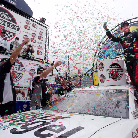 Image: Program alumni, Ruben Garcia Jr., celebrates with No. 6 Max Siegel Inc. Toyota car in the victory lane at Dover International Speedway.