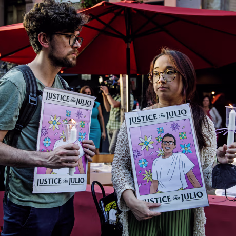 People hold signs for a vigil commemorating Julio Ramirez in New York on June 8, 2022, who died mysteriously after leavig a gay bar in April.