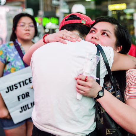 Karinina Quimpo hugs a friend during a vigil for Julio Ramirez on June 8, 2022, in New York. Quimpo was friends with Ramirez for a decade.