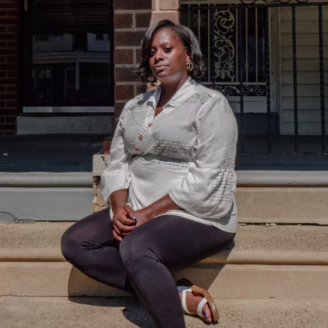 Portrait of April Lee in front of her home in Philadelphia.